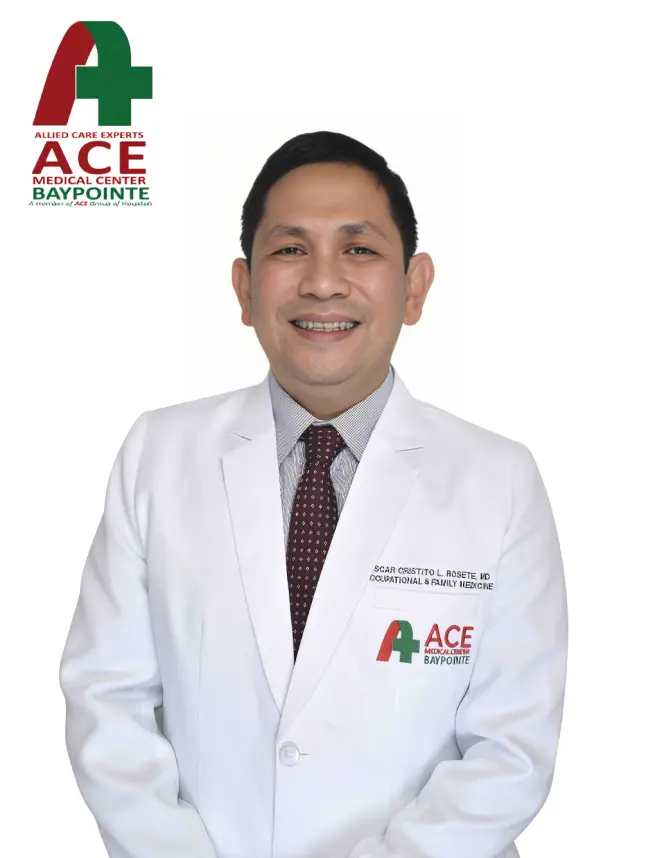 A consultant in a white ACE Baypointe coat over a shirt and tie.